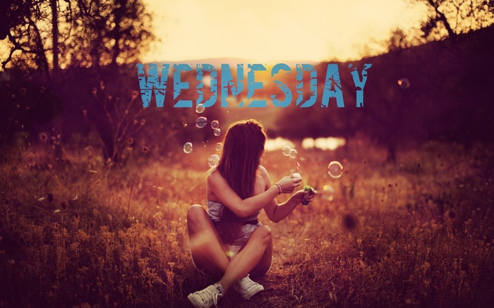 Wednesday, girl blowing bubbles outdoors