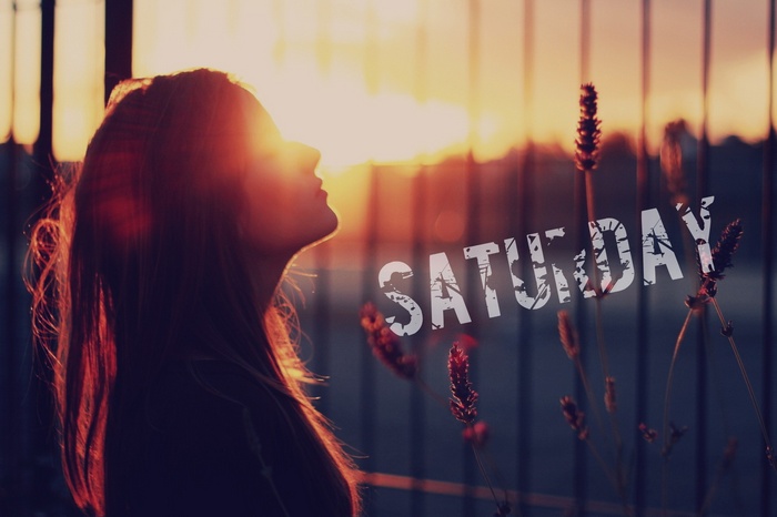 Woman silhouetted against sunset with "SATURDAY" text
