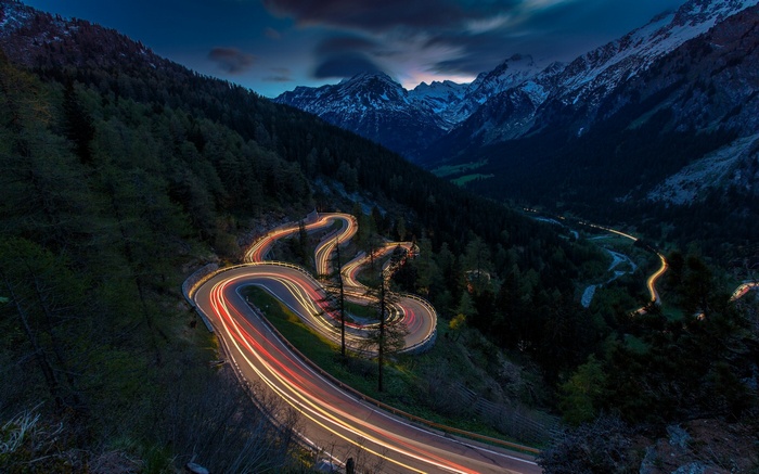 Winding mountain road with light trails in Switzerland