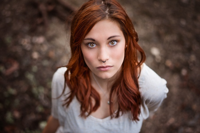 Portrait of a redhead woman with a nose piercing
