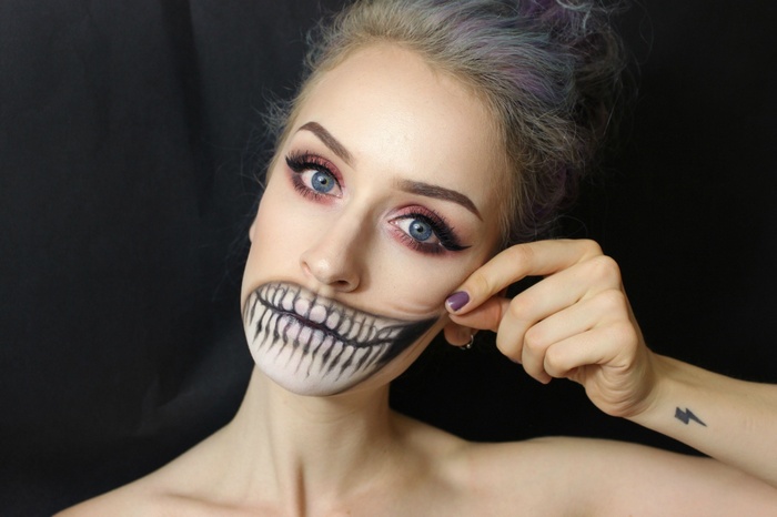 Woman with Halloween makeup showing teeth