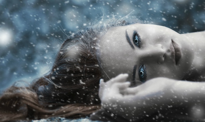 Woman lying down in snow