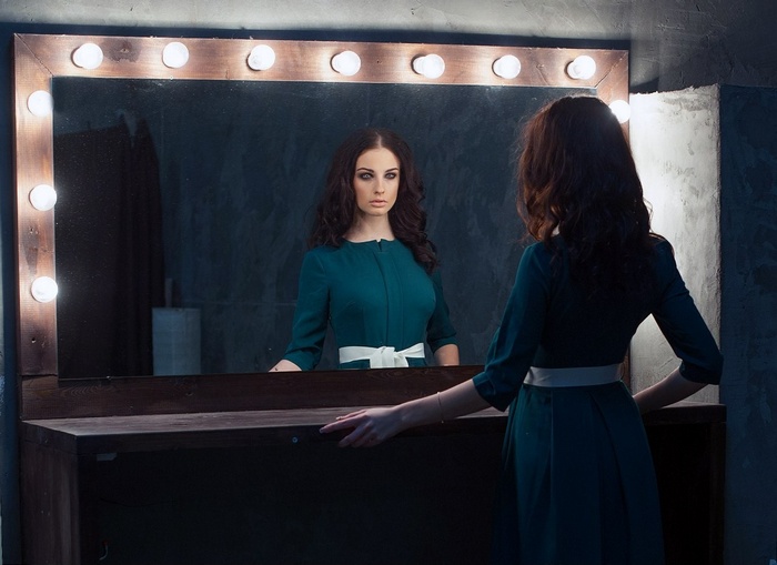 Alla Berger looking in a vanity mirror