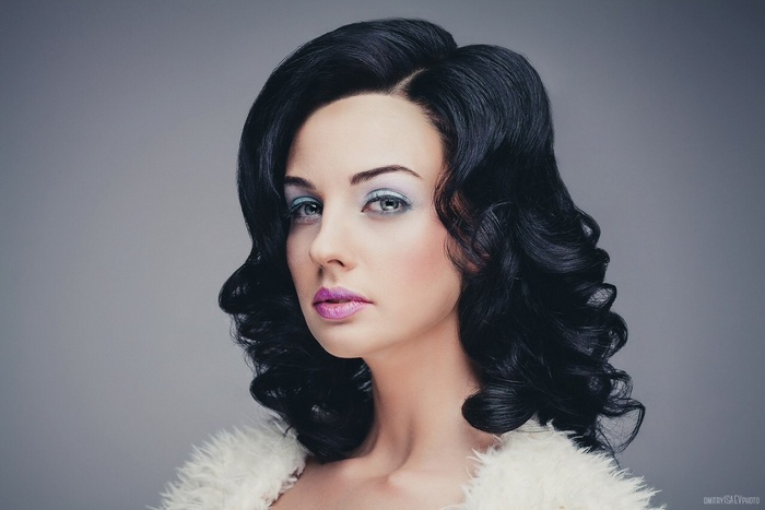 Alla Berger with dark wavy hair and dramatic makeup