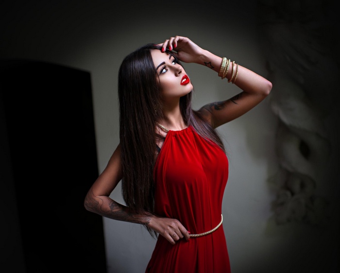 Diana Melison in a red dress with tattoos
