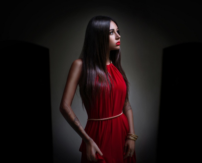 Diana Melison in a red dress with tattoos