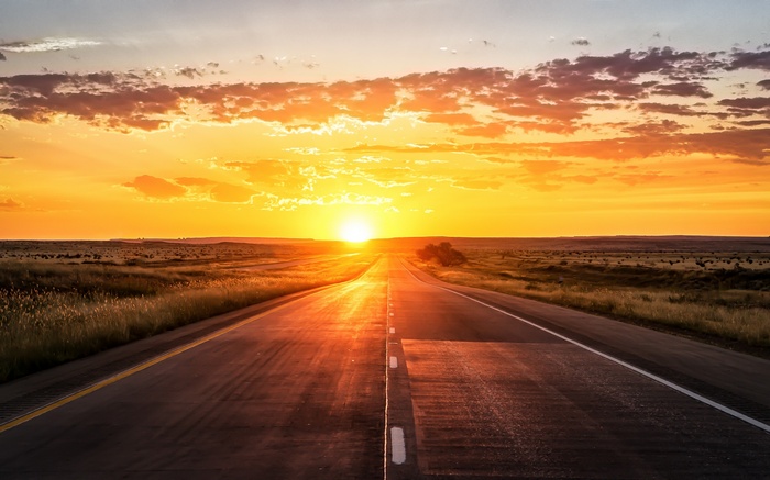 Road at sunset with dramatic clouds