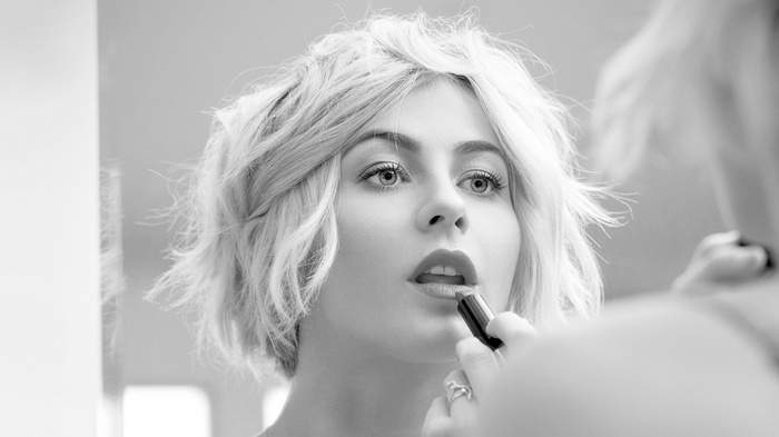 Monochrome closeup of Julianne Hough applying lipstick