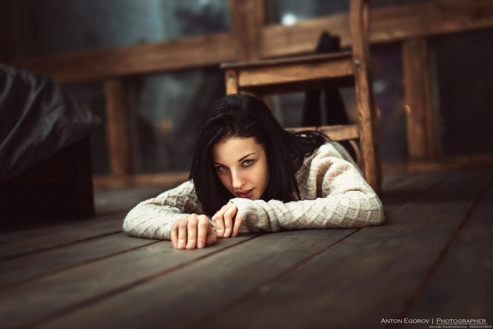 Alla Berger lying on wooden floor wearing sweater