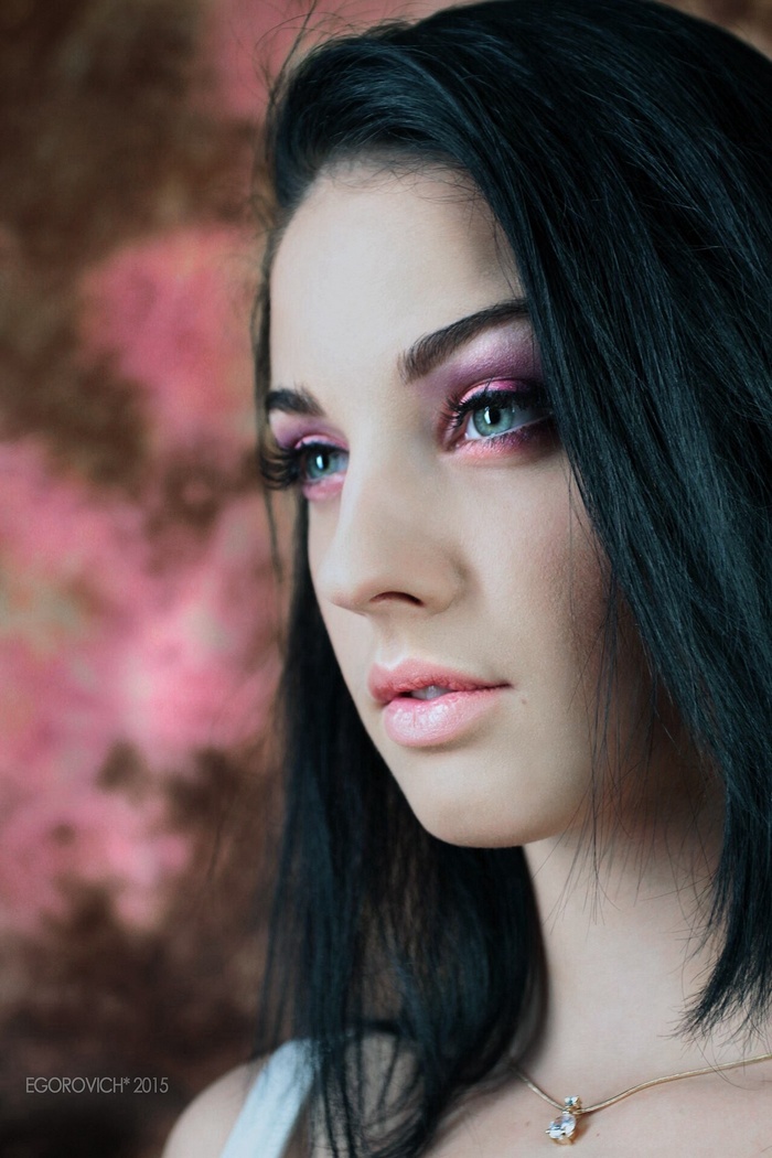 Portrait of a young woman with dark hair and makeup