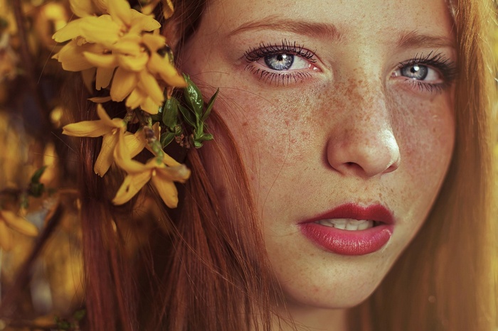 Redhead woman with yellow flowers in her hair