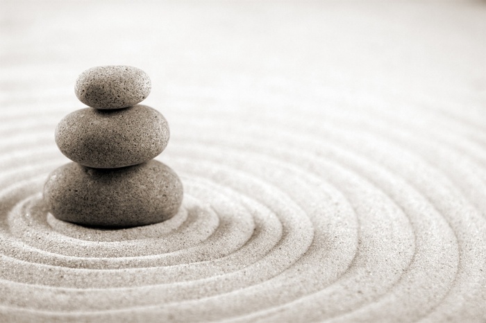 Zen garden with stacked stones and sand ripples