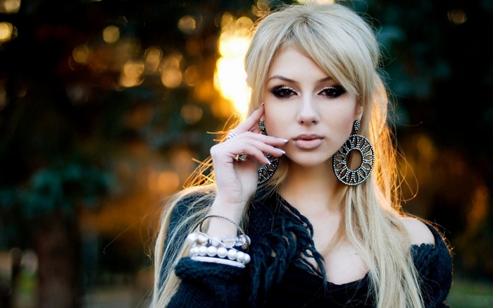 Blonde woman with large earrings and bracelets