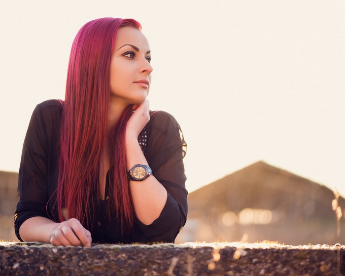 Woman with dyed red hair wearing a black shirt