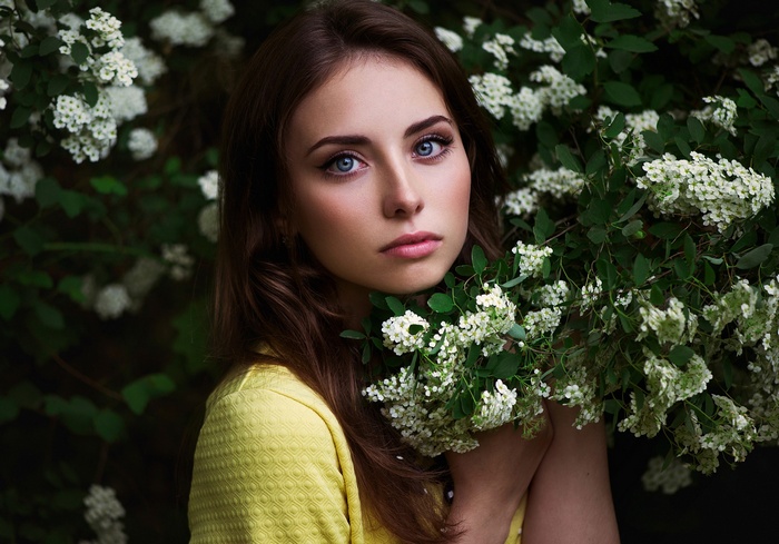 Portrait of Ann Nevreva with blue eyes and flowers