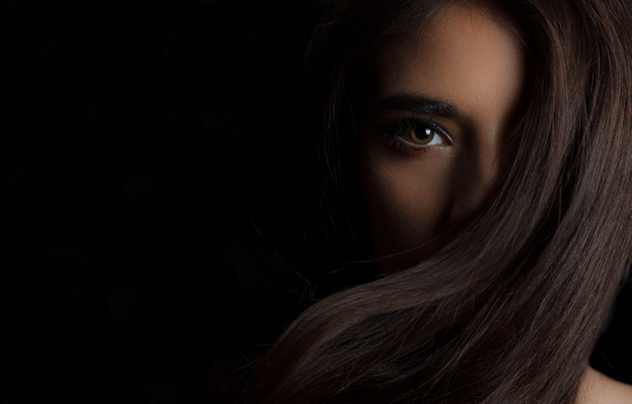 Woman's face partially obscured by hair