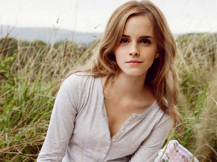 Emma Watson in a field of tall grass
