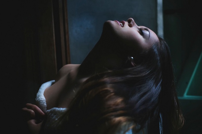 Woman with dark hair tilted back