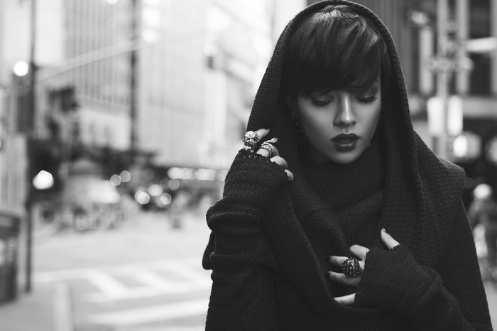 Woman in a hooded coat with rings