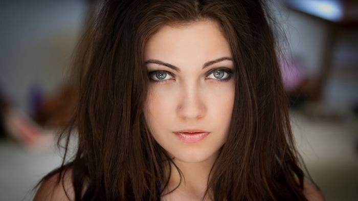 Woman with dark hair looking at the viewer