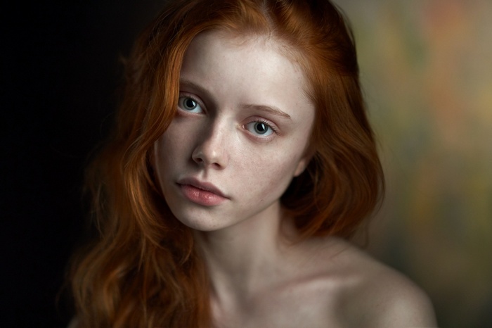 Portrait of a young redhead woman with green eyes