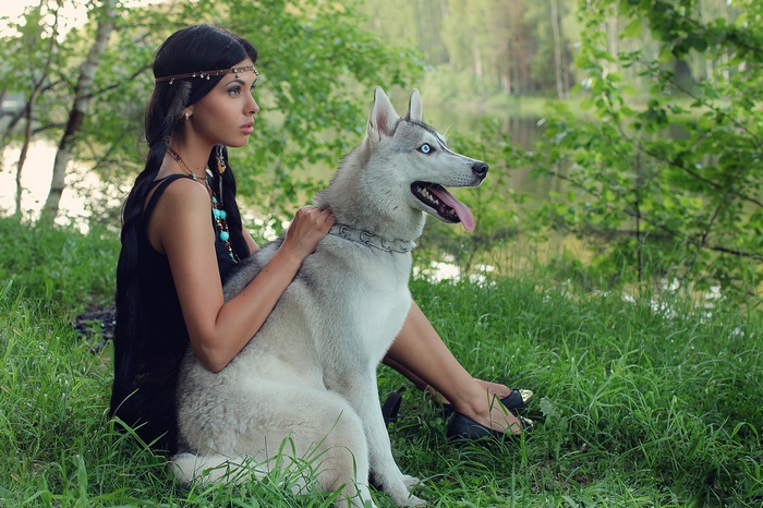 Woman with a husky dog in a forest