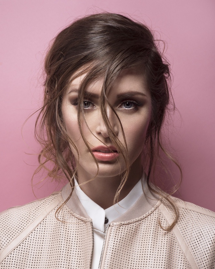Leona Paraminski with messy hair and pink jacket