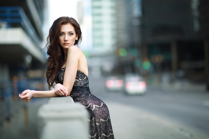 Woman in a black lace dress in a city