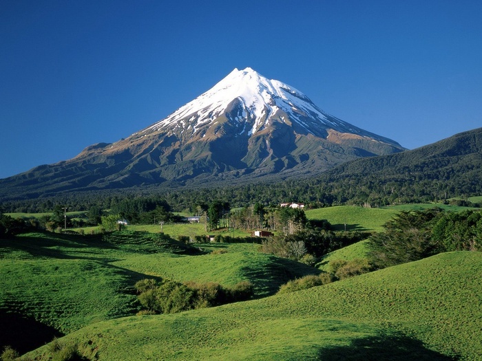 Mount Taranaki covered in snow under a clear blue sky