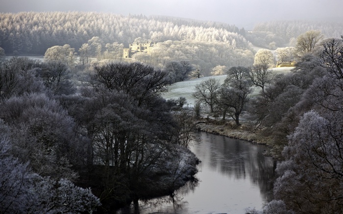 Winter landscape with a river and a castle ruin