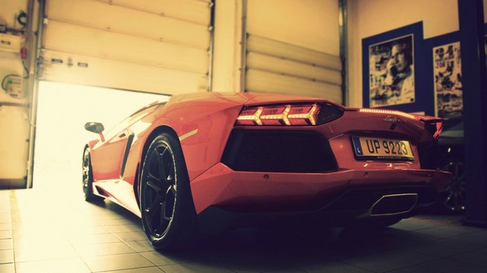 Red Lamborghini Aventador in a garage