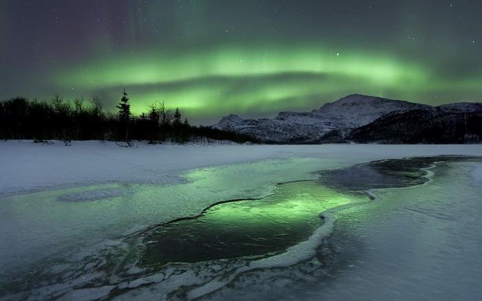 Aurora Borealis over a frozen landscape