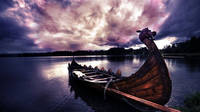 Viking longship on a lake at sunset