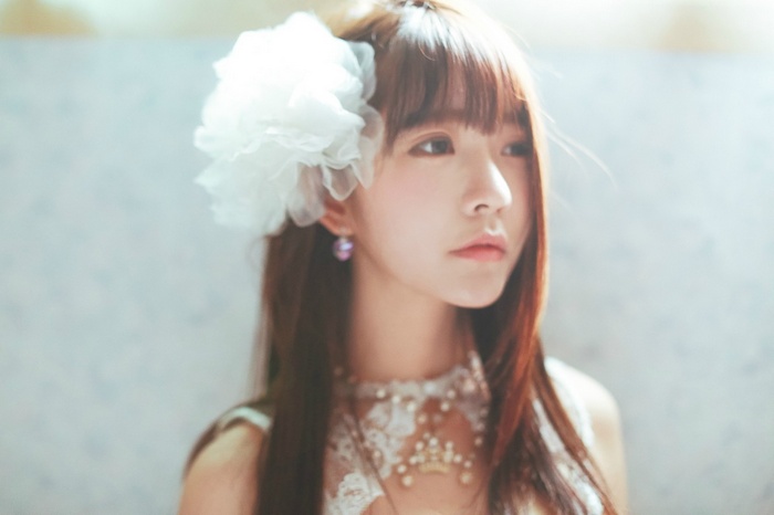 Yurisa Chan with white flower and pearl necklace