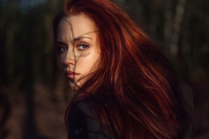 Portrait of a redhead woman with shadows on her face