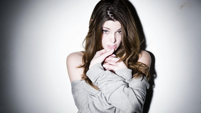 Ashley Greene poses against a white wall