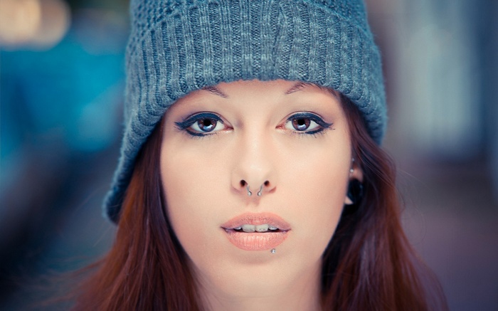 Woman with piercings and beanie