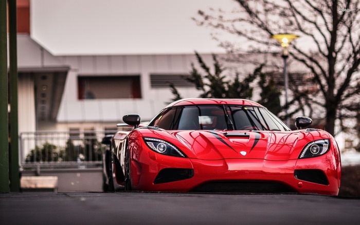 Red Koenigsegg Agera RS parked outside building