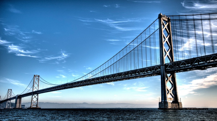 San Francisco-Oakland Bay Bridge under a blue sky