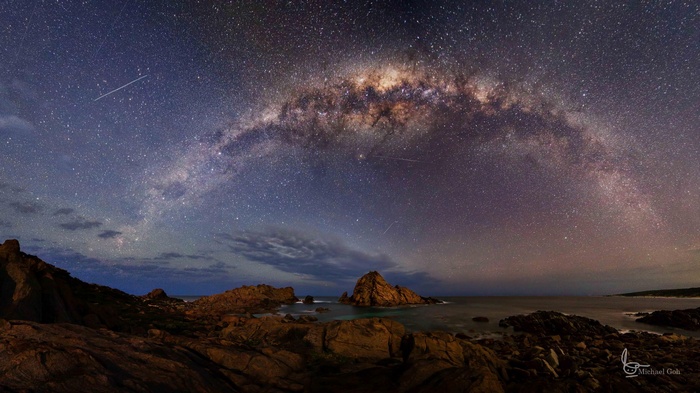 Milky Way over rocky coastline at night