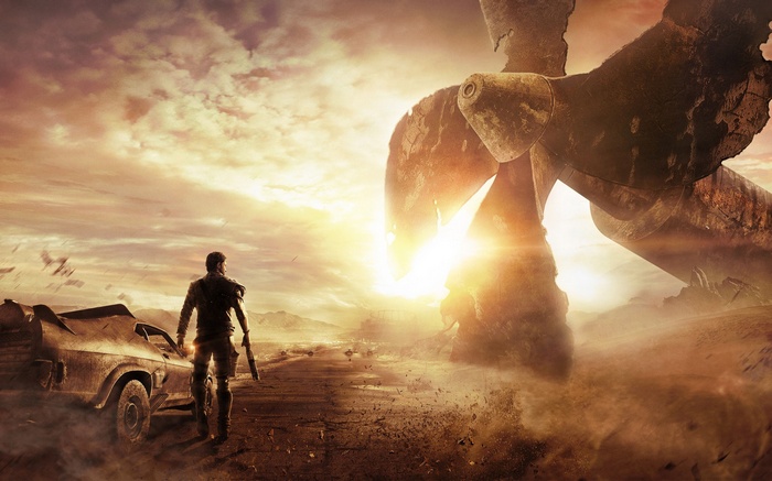 Mad Max standing by his car with a giant propeller