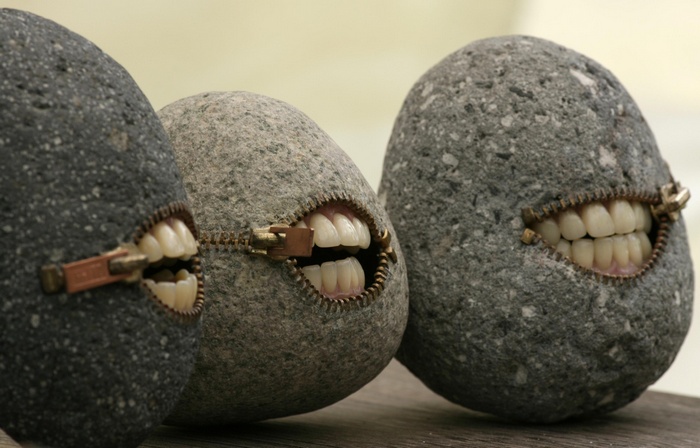 Three rocks with zippers and teeth
