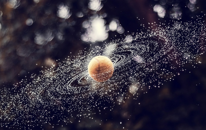 Planet with rings and orbiting particles
