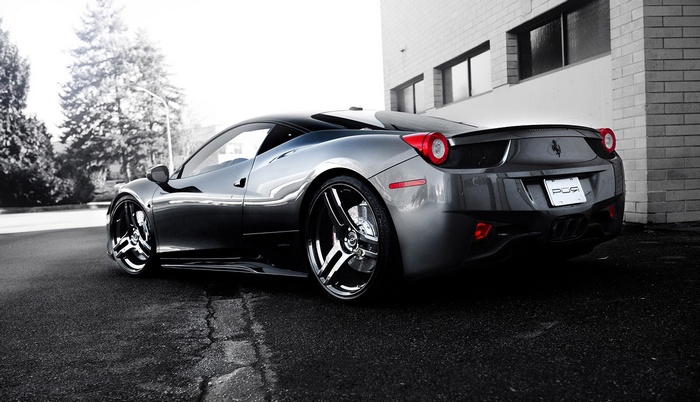 Ferrari 458 Italia parked next to a brick building
