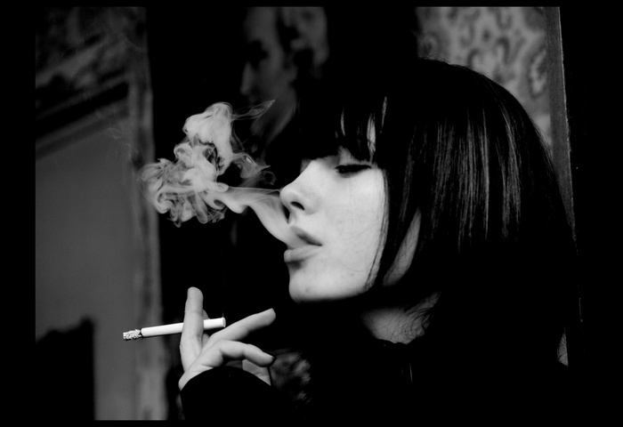 Woman smoking a cigarette, monochrome portrait