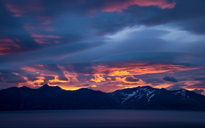 Sunset over mountains and lake