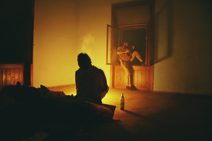 Men playing guitar by the window