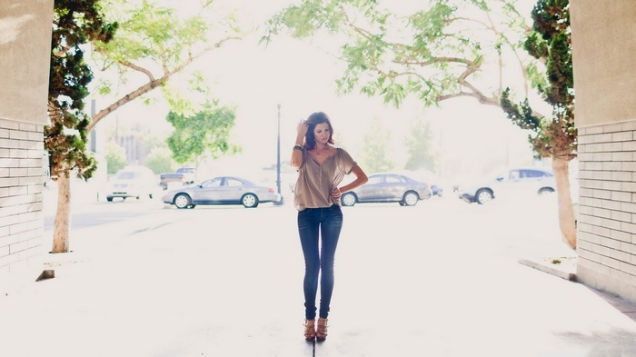 Woman in jeans and a t-shirt standing outdoors