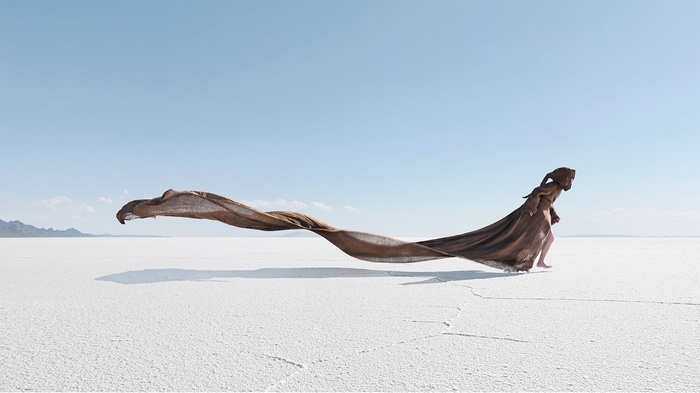 Woman in flowing fabric on a salt flat