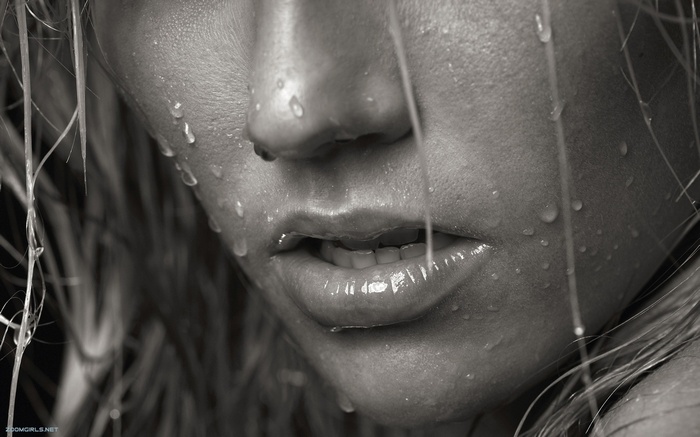 Close-up of a woman's face with water droplets